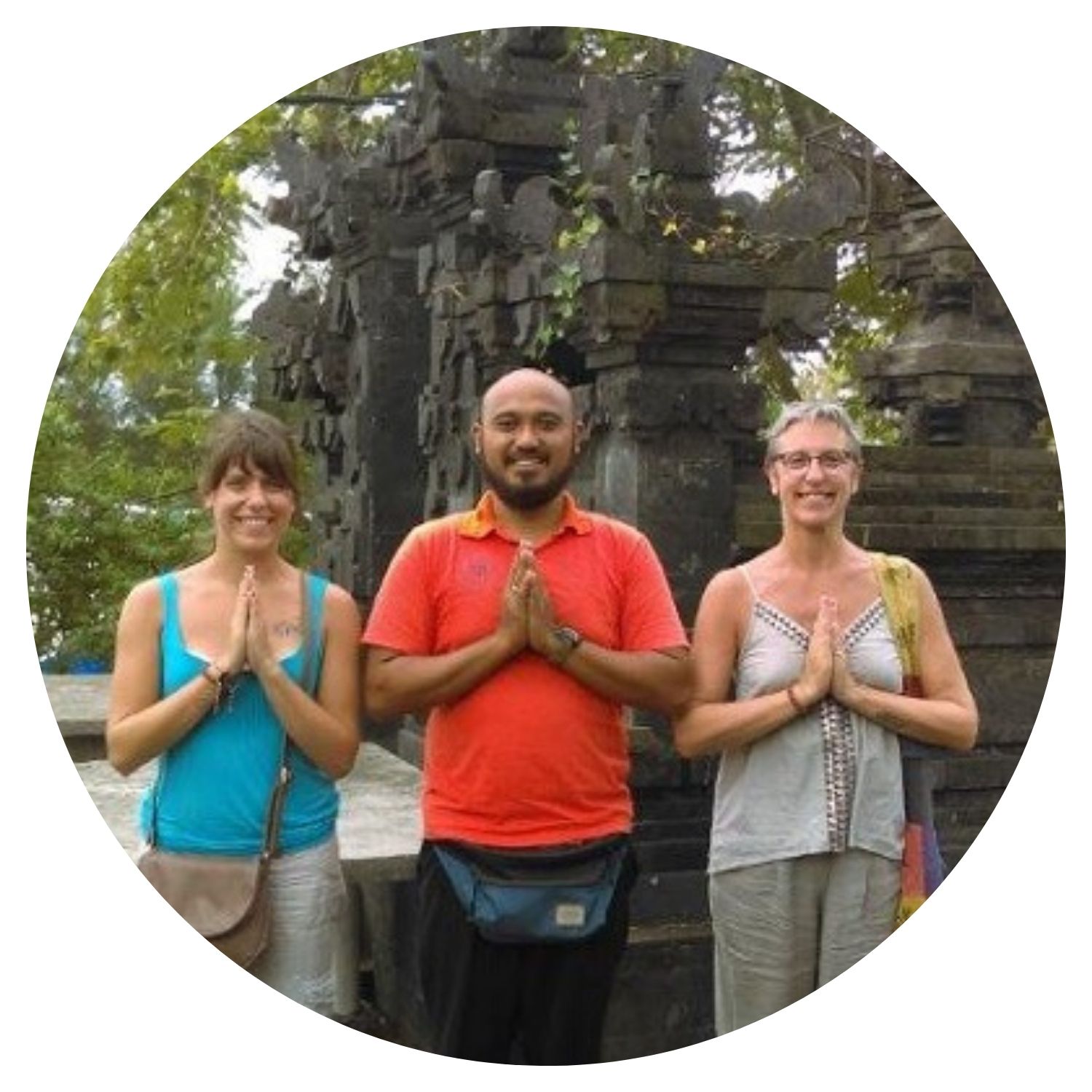 Famille de deux jeunes dames avec un jeune homme prenant une photo devant un monument emblématique de Bali après une visite enrichissante.